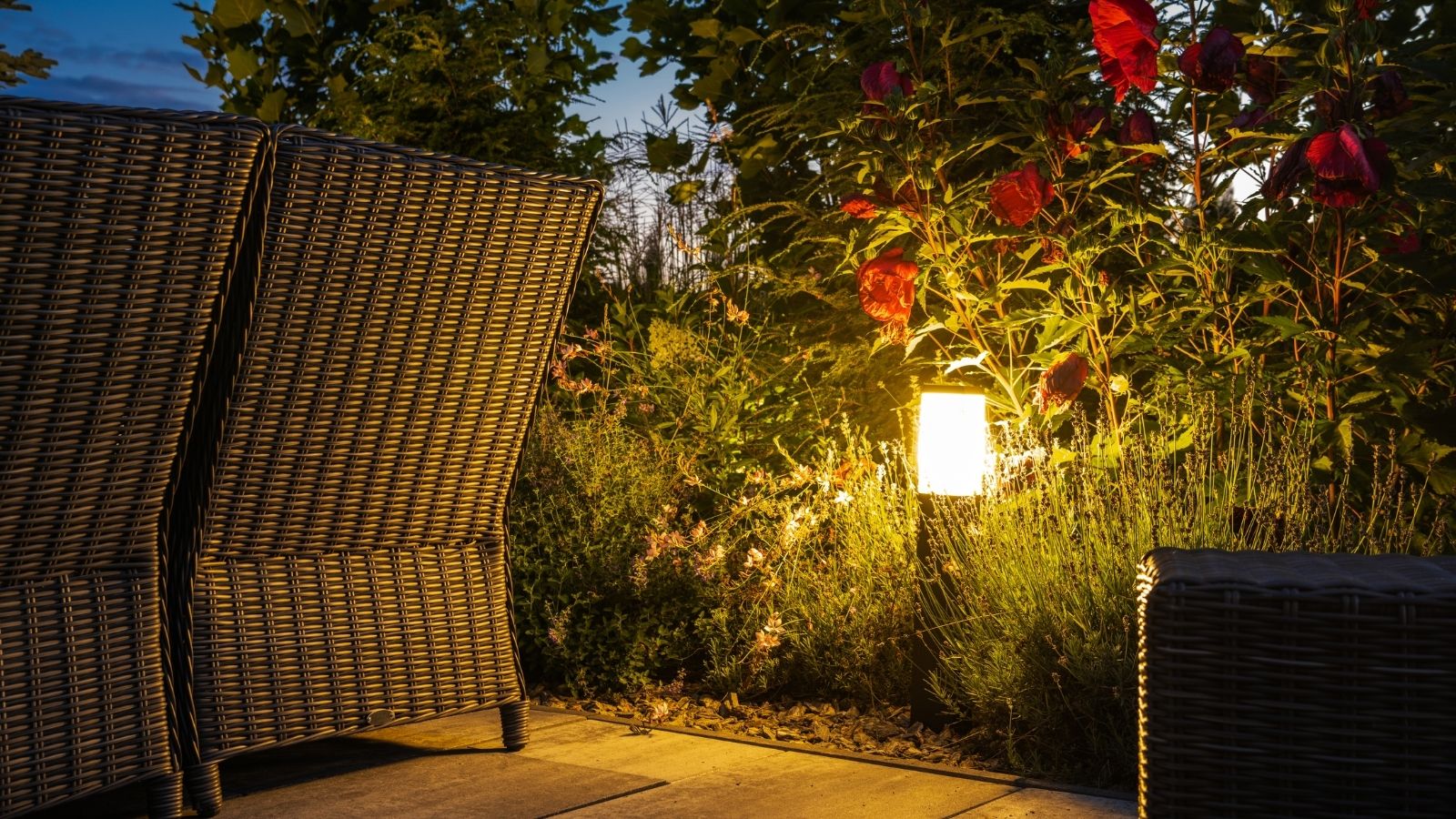 Outdoor property entry with landscape lighting at night